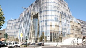 A modern glass building with a curved facade, located at a street intersection. - Les Bonbonières d'Andréa Gavinies Pellegrin Furnished 2* T2 + private roof top 24 sq.m. (Bordeaux)