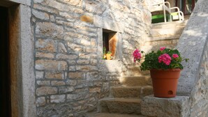A stone staircase leading to a door, with a potted plant on the right. - Istrian villa with swimming pool for an unforgettable holiday  (ZRENJ)