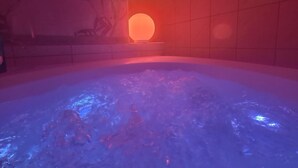 A hot tub with a red ambient light and a tiled wall in the background.