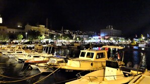 A marina at night with various boats docked.