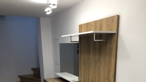 A compact kitchenette with wooden cabinetry, a built-in oven, and a small countertop. - Wendlers Ferienwohnungen 4-6 (Schwaig bei Nuernberg)