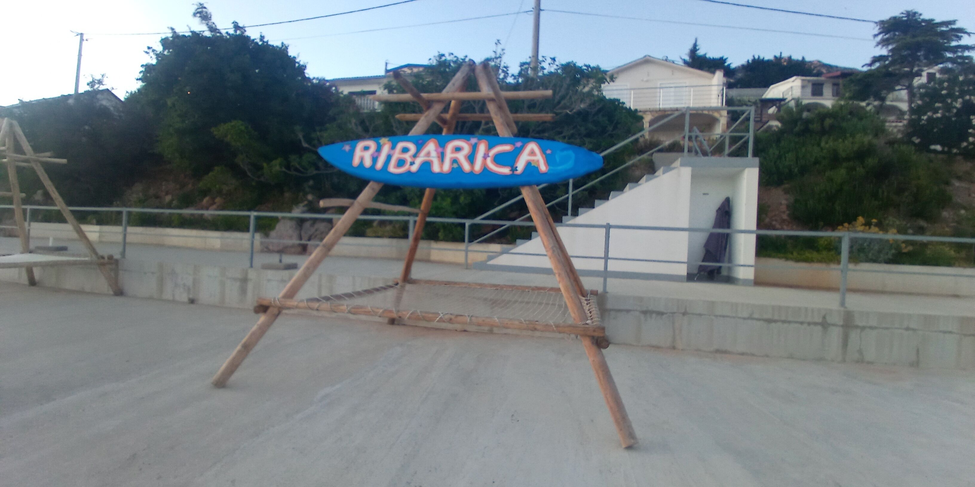 A sign with the word 'RIBARICA' on a wooden stand.