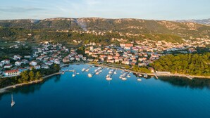 An aerial view of a coastal town with a marina, houses, and mountains in the background. - APARTMENT 67 M2 - A BEDROOM, MODERN, COMFORTABLE LARGE BALCONY, BATH VIEW (Palit)