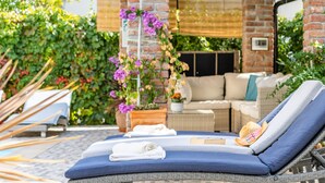 A sun lounge with a blue cushion, a hat, and a towel. - APARTMENT 67 M2 - A BEDROOM, MODERN, COMFORTABLE LARGE BALCONY, BATH VIEW (Palit)