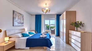 A modern bedroom with a bed, nightstands, a dresser, and a view to the outside. - APARTMENT 67 M2 - A BEDROOM, MODERN, COMFORTABLE LARGE BALCONY, BATH VIEW (Palit)