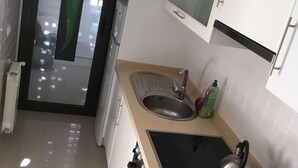 A modern kitchen with a sink, stove, and cabinets. - Very nice house with terrace and pool (Roda)