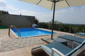 A heated pool, pool loungers