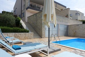A heated pool, pool loungers