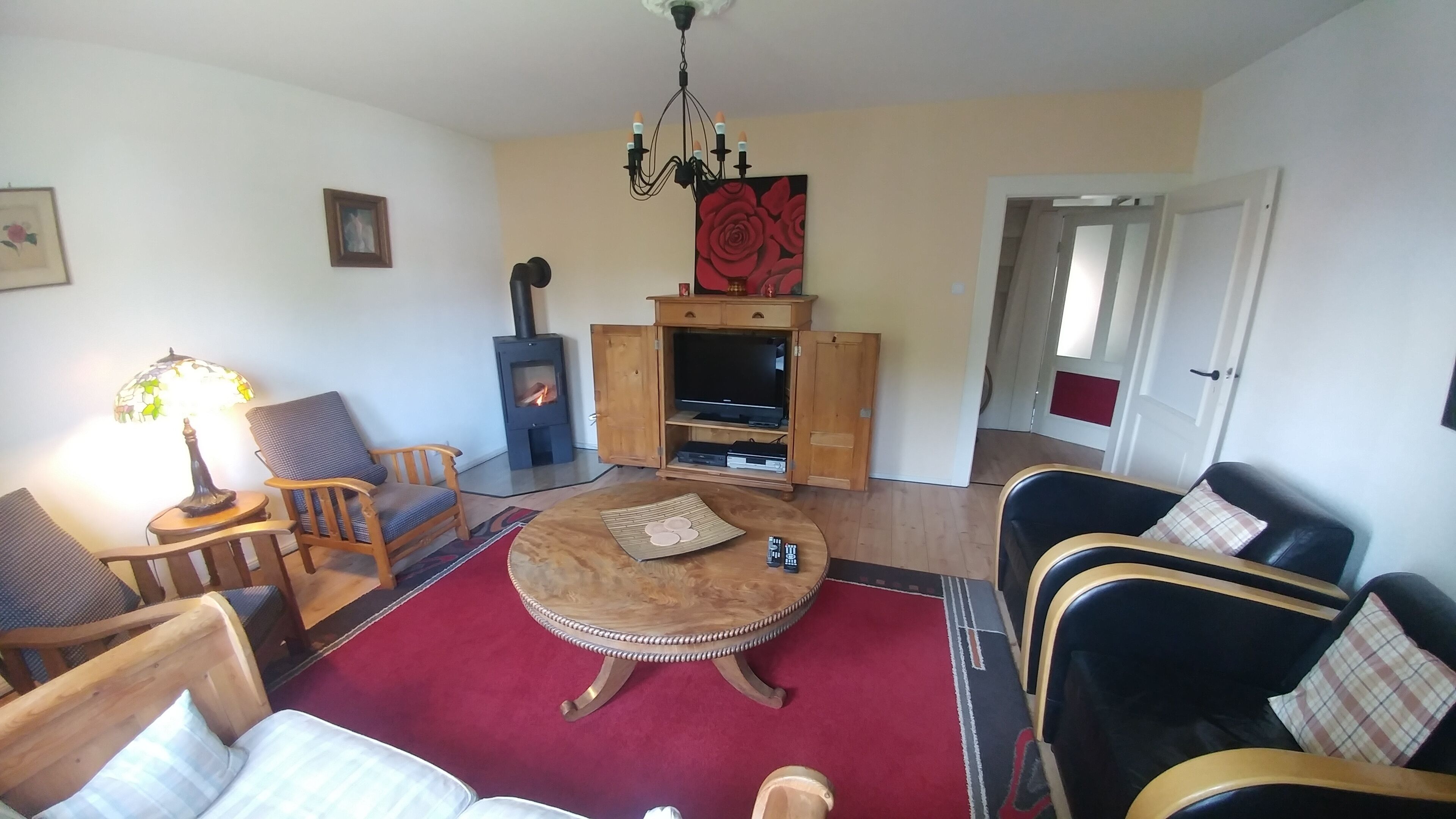 A cozy living room with a fireplace, a round coffee table, and comfortable seating.