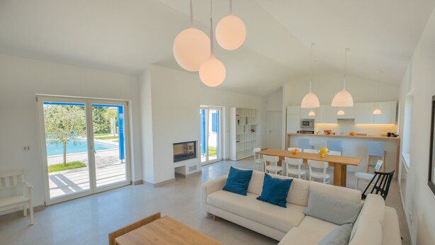 A spacious living area with a sofa, coffee table, and a view of the outdoors. - 3000sqm plot, with 50 sqm heated pool, jacuzzi, 2 tennis courts  (Marčana)