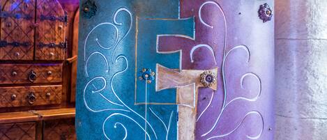 A shield-shaped decorative piece with intricate designs, mounted on a stand.