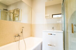 Bathtub, hair dryer, towels, soap