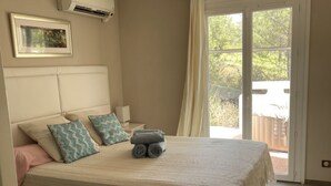 A bedroom with a bed, a window, and a view of the outdoors.