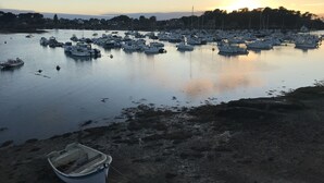 A marina with numerous boats docked, calm water, and a boat on the shore. - Apartment *** approved 2018 - Trestraou Beach (Perros-Guirec)