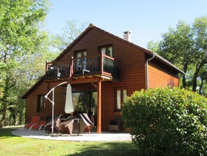 Enjoy a peaceful retreat with a balcony and patio area featuring comfortable seating.