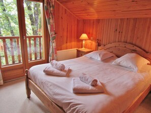 Relax in a serene setting with a comfortable bed and lush views.
