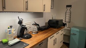 A kitchen with a coffee maker, toaster, and a small refrigerator. - Vacation apartment Westerburg for 1-3 persons in Westerburg city center (Westerburg)