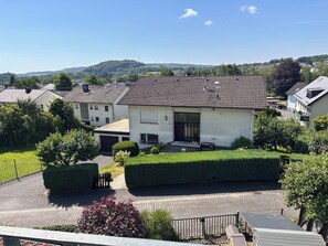 A residential house with a tiled roof, a front porch, and a well-maintained garden. - Vacation apartment Westerburg for 1-3 persons in Westerburg city center (Westerburg)