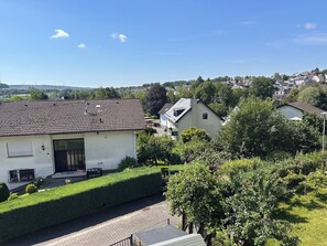 A residential area with houses, a paved driveway, and a clear sky. - Vacation apartment Westerburg for 1-3 persons in Westerburg city center (Westerburg)