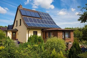 A house with a sloped roof and solar panels. - family-friendly apartment on Greifswalder Bodden on the beautiful island Rüge (Putbus)