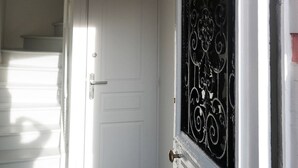 A white door with a sign above it reading "BEACH HOUSE."