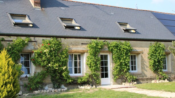 A building with a sloped roof, three skylights, and a stone facade. - House completely renovated in the countryside in tourist village (Saint-Evroult-Notre-Dame-du-Bois)