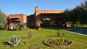 A modern house with a pool, surrounded by a well-maintained lawn and garden. - Villa Kristy Junior (2 bedrooms + Private pool) (Marrakesh)