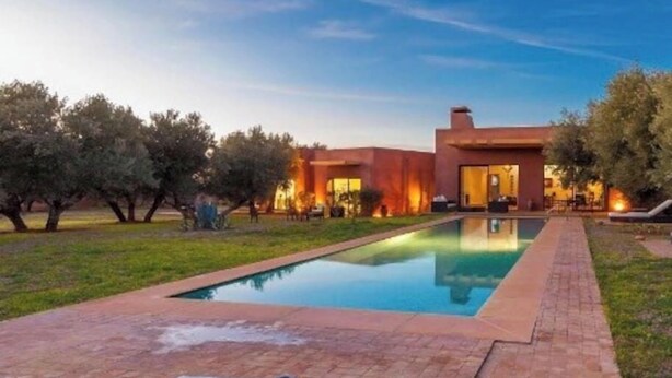 A modern pool area with a clear pool, a brick pathway, and a building with warm lighting in the background. - Villa Kristy Junior (2 bedrooms + Private pool) (Marrakesh)