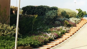 A staircase with brick steps leading up to a landscaped area with various plants and flowers. - 6P apartment in Collioures / 10 min from Argelès / Waterfront (Pyrénées-Orientales)
