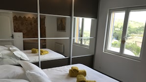 A hotel room with two beds, white linens, and yellow towels. - La Casa, Charming little house of Provence  (Ongles)