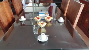 A dining table set with a box of Gavottes, four glasses, a teapot, and a cup. - Air-conditioned Provencal villa, 300 m2 garden, quiet location, walking distance to beaches and village (Villeneuve-Loubet)