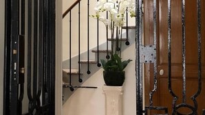 A staircase with a white railing, a potted plant, and a black ornate gate. - 110m2 of relaxation in the center, VISA, sun, sea and mountains (Perpignan)
