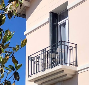Guests can enjoy a balcony with a wrought iron railing.