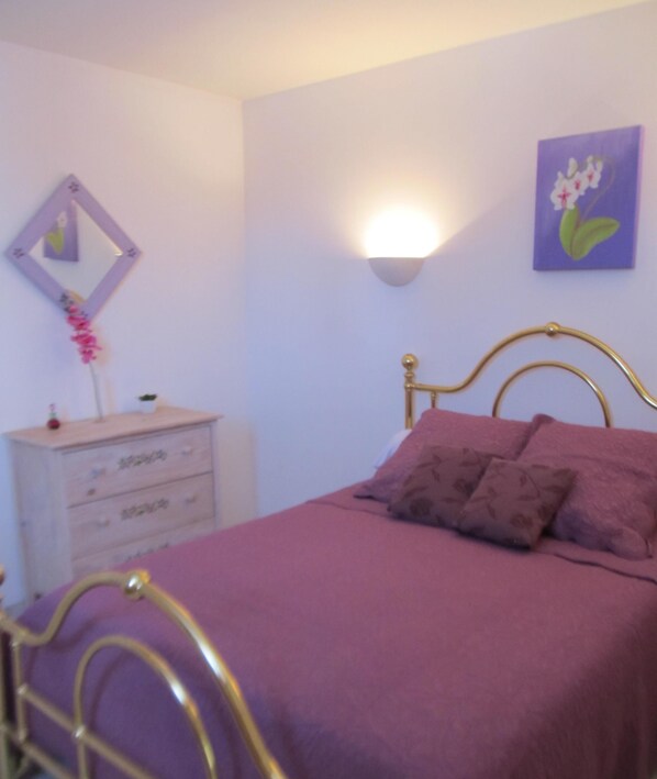 A bedroom with a bed, a dresser, a wall-mounted light, and a painting. - T2 of 40 m² in Agde near (Agde)