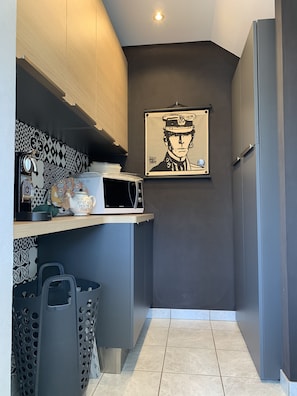 A compact kitchen with a microwave, a small refrigerator, and a sink. A framed picture hangs on the wall above the counter. - Architect house 10 pers - 220 m2 - Near Beach (Plouër-sur-Rance)