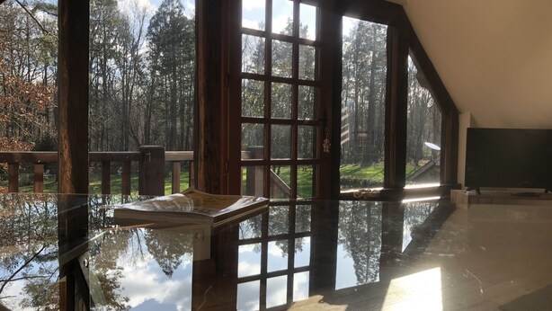 A spacious room with large windows offering a view of a forested area. - Studio in a park near Chambord (ST LAURENT NOUAN)