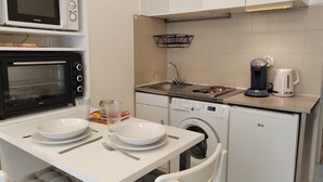 Pieni, käytännöllinen keittiönurkkaus, jossa on mikroaaltouuni, leivänpaahdin, pesuallas ja kahvinkeitin.