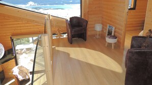 A wooden cabin interior with a large window overlooking a lake and mountains. - CERF apartment in new chalet with view of Matemale lake 12 beds (Les Angles)
