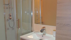 A modern bathroom with a glass-enclosed shower, a white sink, and a wooden vanity. - CERF apartment in new chalet with view of Matemale lake 12 beds (Les Angles)