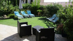 A patio with three blue lounge chairs, a black wicker table, and a potted plant. - 3P RDJ air-conditioned apartment in residence with swimming pool and tennis court in St Aygulf (Unknown)
