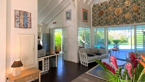 A spacious living area with a kitchen, a dining area, and a view of the outdoors.
