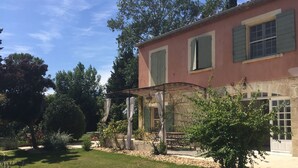 A two-story house with a garden, a pergola, and a patio area. - Magnificent in the heart of Provence (Maillane)
