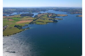 An aerial view of a coastal landscape with multiple islands and a large body of water.