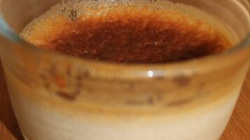 A clear glass bowl containing a layered mixture of brown and white substances.