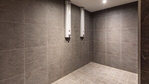 A modern bathroom with dark stone tiles, two wall-mounted towel dispensers, and a shower area. - 110m² apartment, full services 4 *, 3 bedrooms, 3 bathrooms / d, south balcony and 2 parking spaces (Montvalezan)