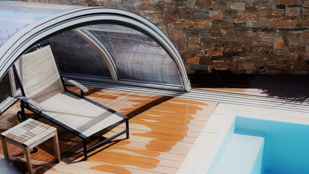A covered outdoor seating area with a pool.