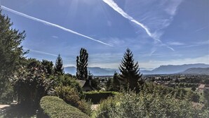 A landscape with a clear sky, distant mountains, and a town in the background.