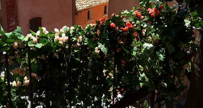 "LA DAME AU BALCON" on the village square