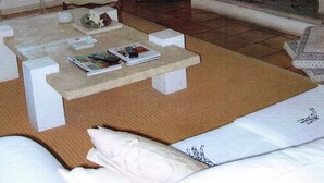 A living room with a fireplace, a television, a sofa, and a coffee table.