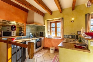 A compact kitchen with a microwave, stove, and sink. - "6 PEOPLE, LES PERRIERES, BURGUNDY SAS MAYMARD ANTULLY 0611375830 (3 vacation rentals = 17 people)" (Antully)